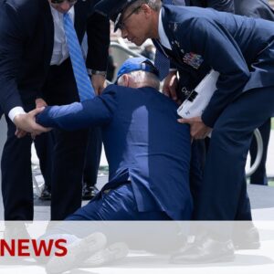 US President Biden trips and falls over at graduation event – BBC News
