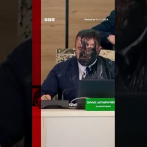 Moment Georgia election cheif doused in paint by opposition official. #Georgia #BBCNews