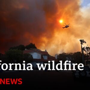 California wildfire rips through LA suburbs as 30,000 told to evacuate | BBC News