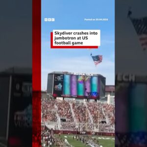 Skydiver crashes into jumbotron at US football game. #Virginia #BBCNews